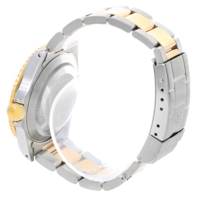 The image shows a side view of a Rolex Submariner 16613 Men's Steel and Gold (two tone) Black Dial 16613 Men's Steel and Gold (two tone) Black Dial watch, highlighting its case back, crown, and two-tone bracelet.