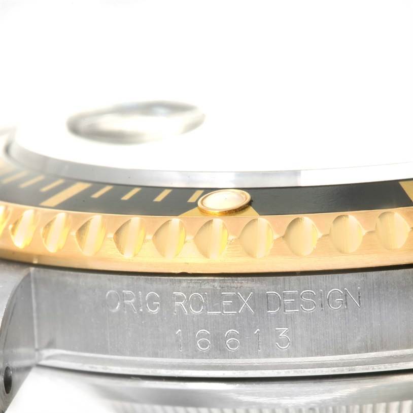 The image shows a close-up of the bezel and case side of a Rolex Submariner 16613 Men's Steel and Gold (two tone) Black Dial 16613 Men's Steel and Gold (two tone) Black Dial, highlighting the "ORIG ROLEX DESIGN" and "16613" engravings.