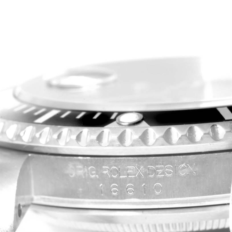 This image shows a close-up view of the bezel and case side of a Rolex Submariner 16610 Men
s Stainless Steel Black Dial 16610 Men
s Stainless Steel Black Dial, including the engraved model number.