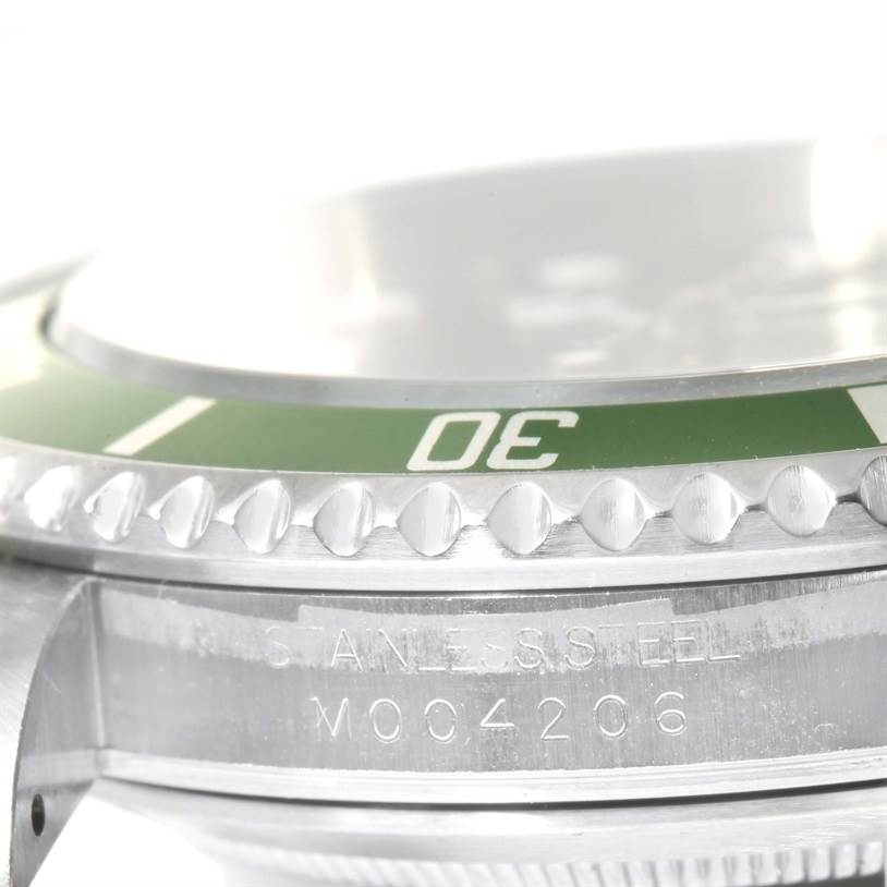 This image shows a close-up, side-angled view of the bezel and serial number of a Rolex Submariner 16610LV Men
s Stainless Steel Black Dial 16610LV Men
s Stainless Steel Black Dial watch.