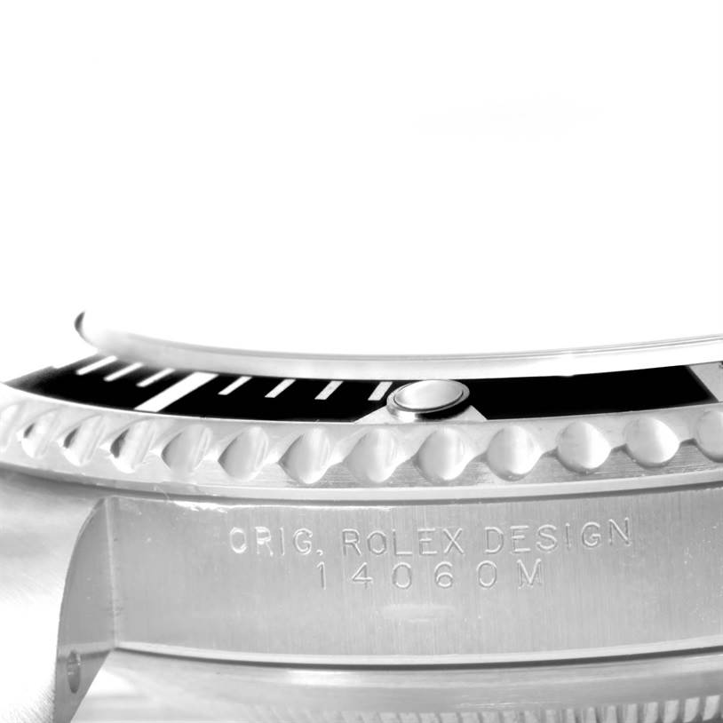 This image shows a close-up of the bezel and case side of a Rolex Submariner 14060 Men
s Stainless Steel Black Dial 14060 Men
s Stainless Steel Black Dial watch, highlighting the engravings and part of the bezel
s edge.