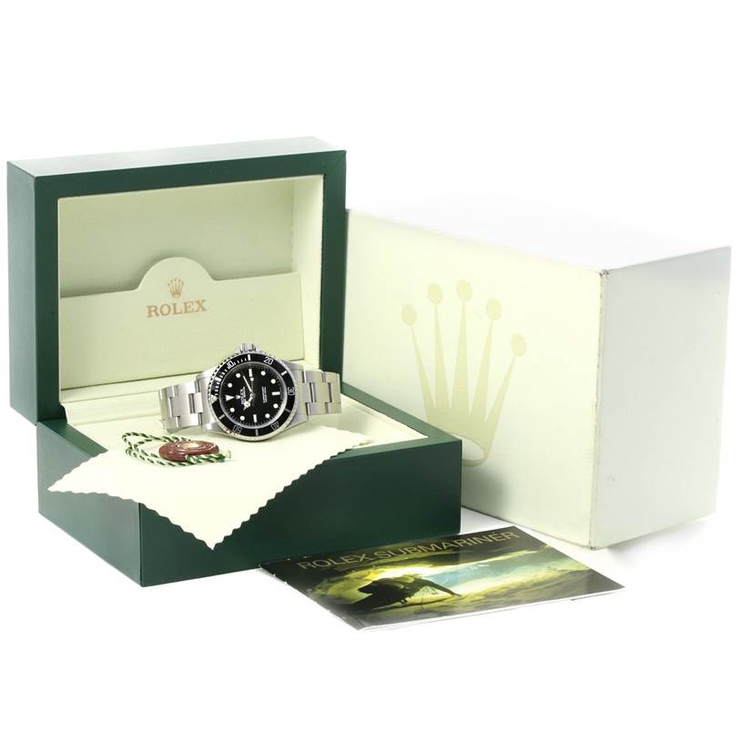 The image shows a Rolex Submariner 14060 Men
s Stainless Steel Black Dial 14060 Men
s Stainless Steel Black Dial watch inside its open box, accompanied by a booklet, tags, and outer packaging box.