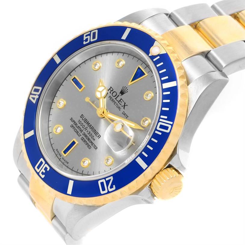 This image shows a Rolex Submariner 16613 Men's Steel and Gold (two tone) Grey Dial 16613 Men's Steel and Gold (two tone) Grey Dial watch from an angled view, highlighting its dial, bezel, crown, and part of the bracelet.