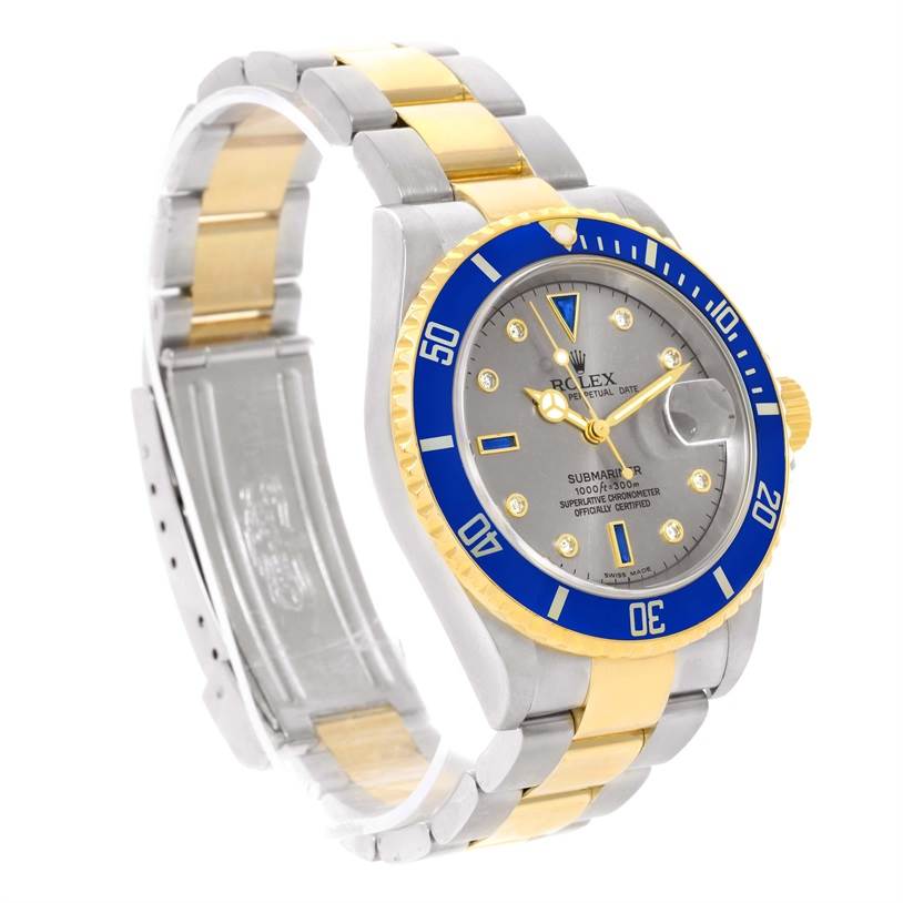 This image shows a Rolex Submariner 16613 Men's Steel and Gold (two tone) Grey Dial 16613 Men's Steel and Gold (two tone) Grey Dial watch at a slight angle, highlighting its face, bezel, and two-tone bracelet.
