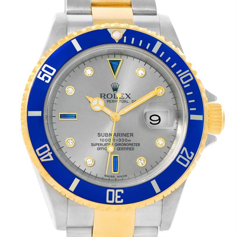 The image shows a front view of a Rolex Submariner 16613 Men's Steel and Gold (two tone) Grey Dial 16613 Men's Steel and Gold (two tone) Grey Dial watch featuring a blue bezel, a gold-and-steel bracelet, and a grey dial.