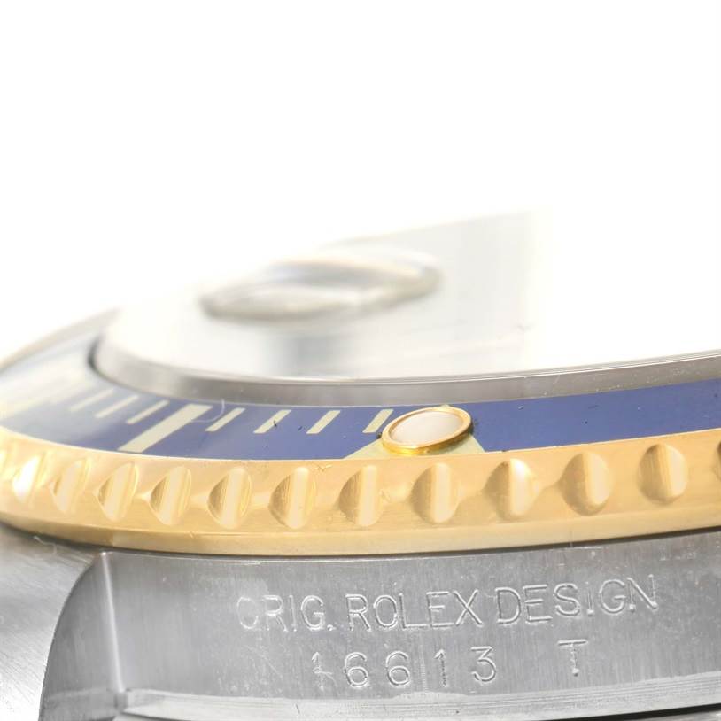 The image shows a close-up side angle of the bezel and part of the case of a Rolex Submariner 16613 Men's Steel and Gold (two tone) Grey Dial 16613 Men's Steel and Gold (two tone) Grey Dial 16613.