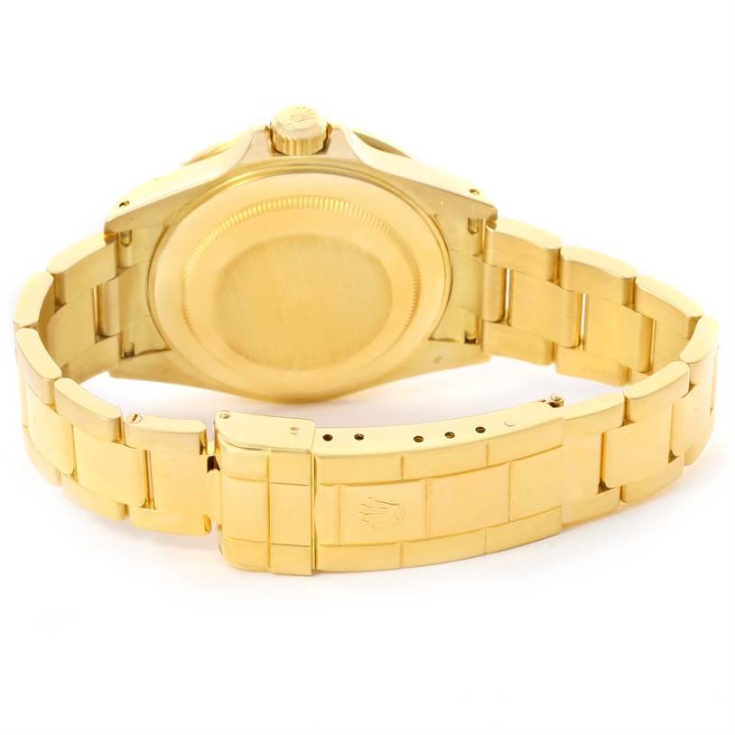 The image shows the back and clasp of a gold Rolex Submariner 16618 Men
s Yellow Gold Black Dial 16618 Men
s Yellow Gold Black Dial watch, viewed from the rear.
