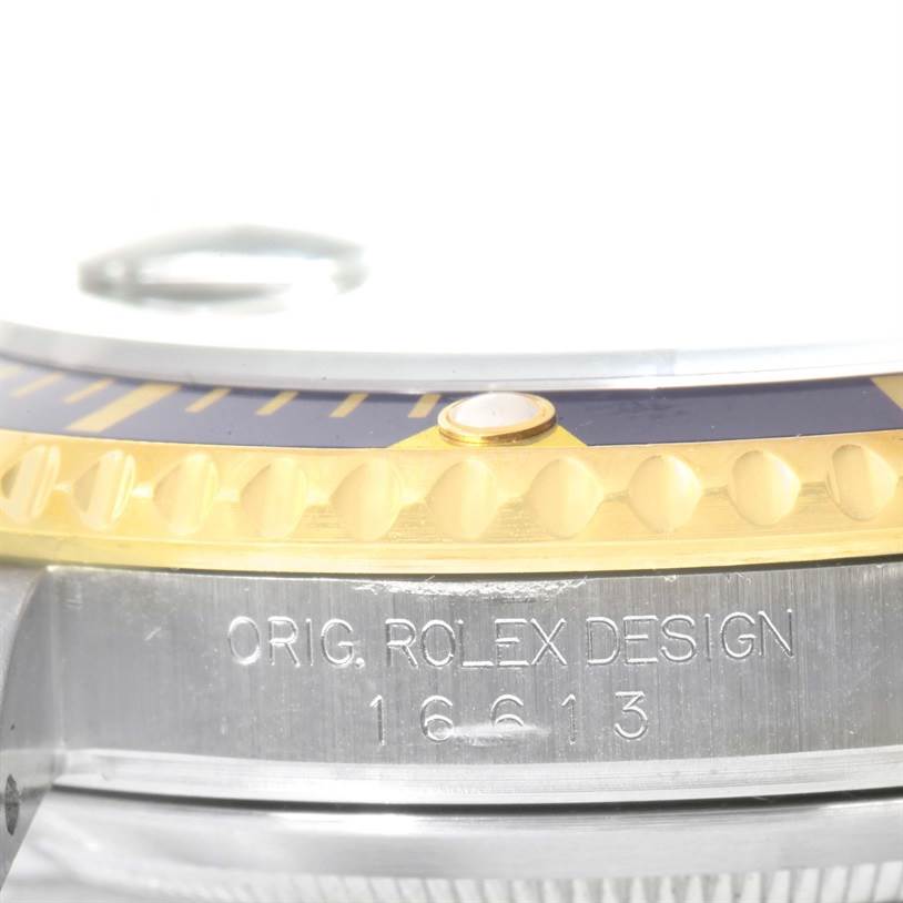 This close-up image shows the bezel and part of the case of the Rolex Submariner 16613 Men's Steel and Gold (two tone) Blue Dial 16613 Men's Steel and Gold (two tone) Blue Dial watch.