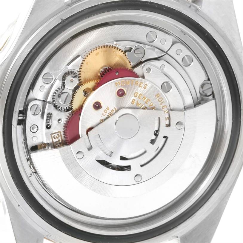 This image shows a close-up of the movement and inner mechanical parts of a Rolex Submariner 16613 Men's Steel and Gold (two tone) Blue Dial 16613 Men's Steel and Gold (two tone) Blue Dial watch.