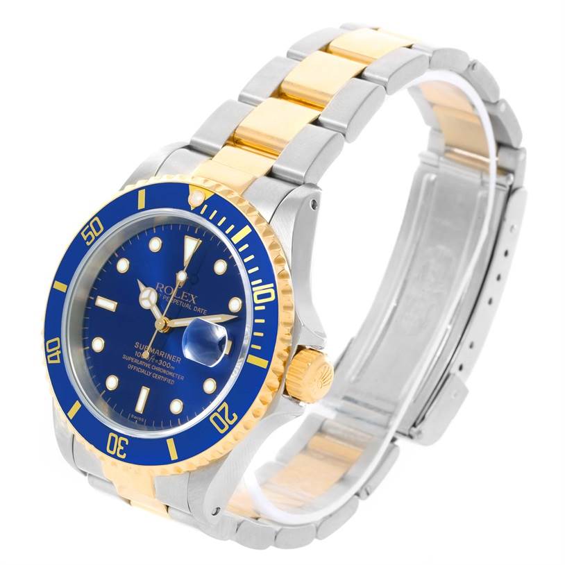The image displays a Rolex Submariner 16613 Men's Steel and Gold (two tone) Blue Dial 16613 Men's Steel and Gold (two tone) Blue Dial watch at an angle showcasing its blue dial, bezel, and the bimetallic bracelet with gold center links.