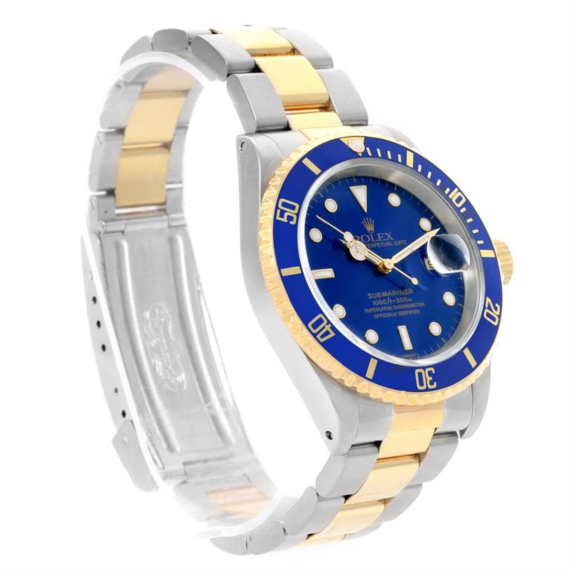 This image shows a Rolex Submariner 16613 Men's Steel and Gold (two tone) Blue Dial 16613 Men's Steel and Gold (two tone) Blue Dial watch at an angled side view, highlighting its blue dial, two-tone bracelet, and bezel.