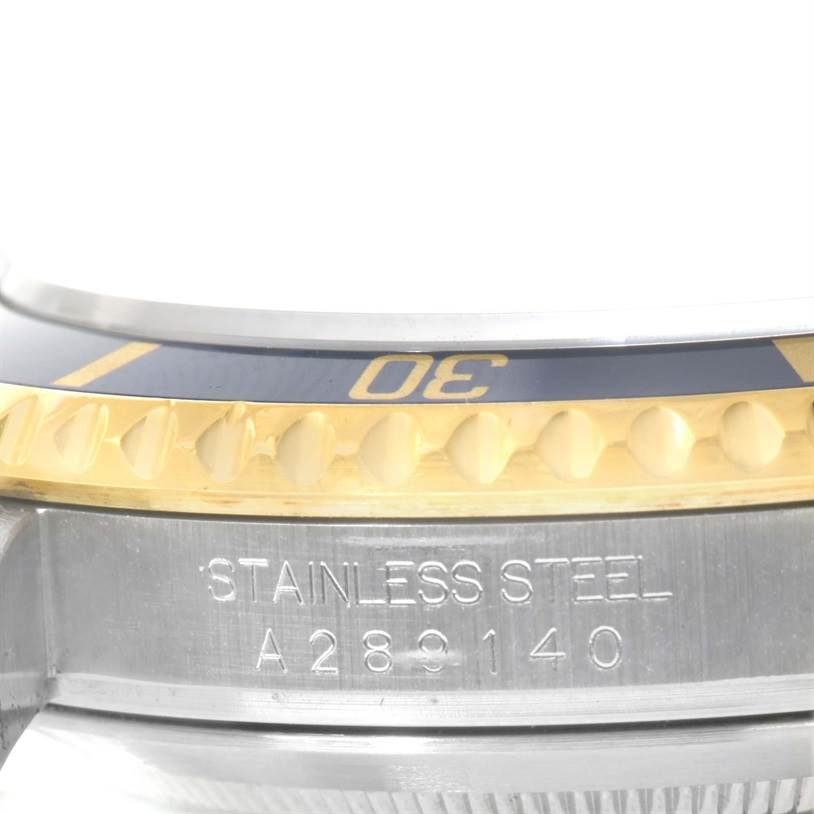 The image shows a close-up of the stainless steel case and partially visible bezel of a Rolex Submariner 16613 Men's Steel and Gold (two tone) Blue Dial 16613 Men's Steel and Gold (two tone) Blue Dial watch.