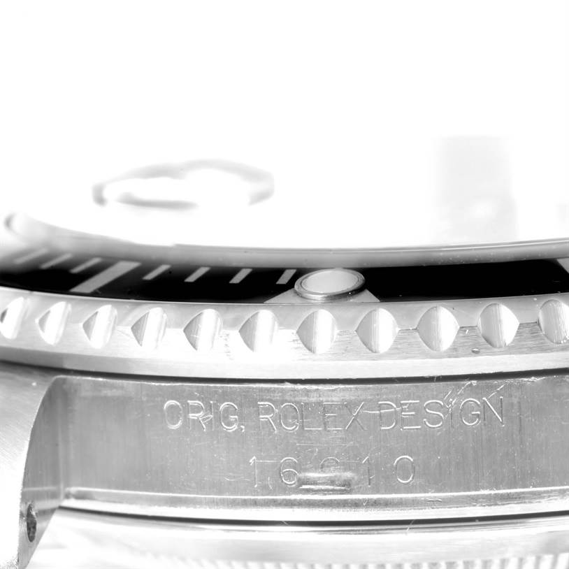 The image shows a close-up of the side of a Rolex Submariner 16610 Men
s Stainless Steel Black Dial 16610 Men
s Stainless Steel Black Dial, highlighting the bezel and engraved model details.
