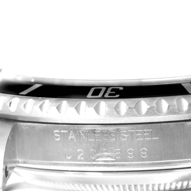 Close-up of the Rolex Submariner 16610 Men
s Stainless Steel Black Dial 16610 Men
s Stainless Steel Black Dial
s bezel and case showing engraved details.