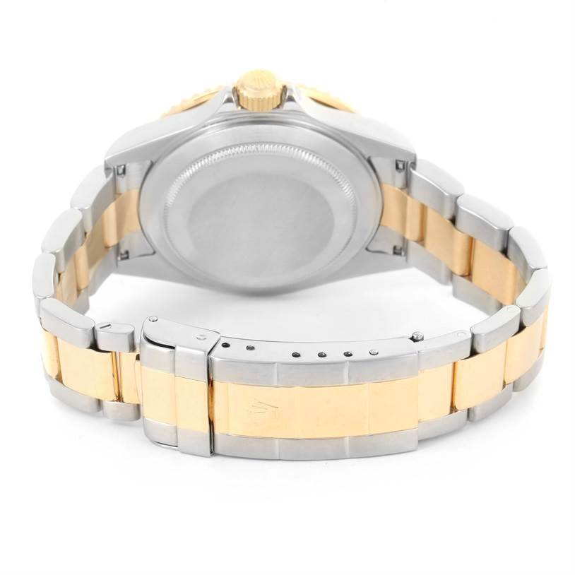 This image shows the backside and bracelet of a Rolex Submariner 16613 Men
s Steel and Gold (two tone) Black Dial 16613 Men
s Steel and Gold (two tone) Black Dial watch with a two-tone metal design.