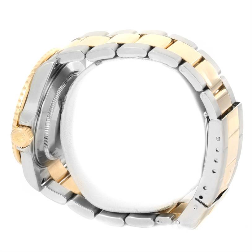 The image shows a side view of a Rolex Submariner 16613 Men
s Steel and Gold (two tone) Black Dial 16613 Men
s Steel and Gold (two tone) Black Dial watch, highlighting its two-tone bracelet and crown.