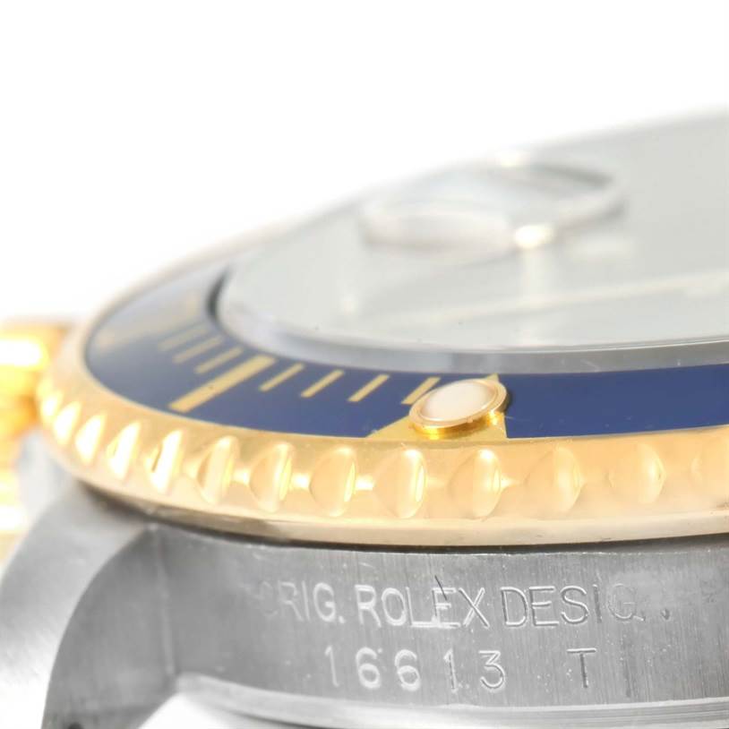 This close-up angle of a Rolex Submariner 16613 Men
s Steel and Gold (two tone) Black Dial 16613 Men
s Steel and Gold (two tone) Black Dial shows the bezel, part of the case, and engraved model details.