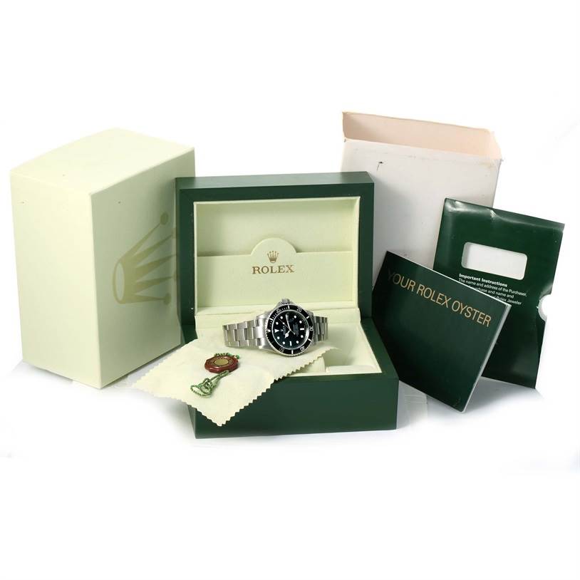 The image shows a Rolex Submariner 16610 Men
s Stainless Steel Black Dial 16610 Men
s Stainless Steel Black Dial watch in its open box, with accessories like the manual and Best Quality
ation tags visible.