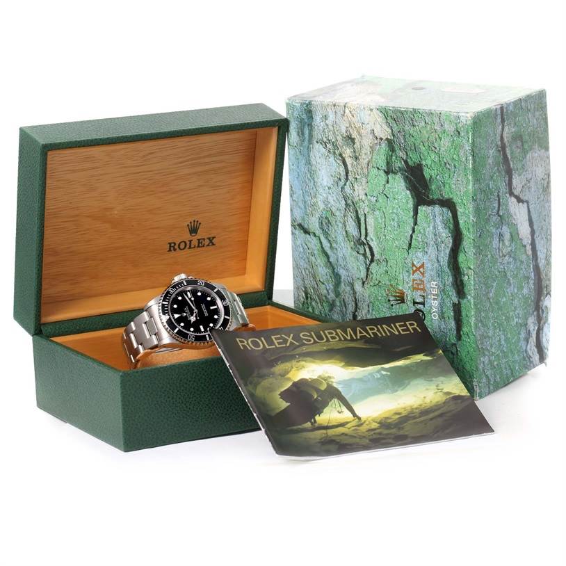 The Rolex Submariner 14060 Men
s Stainless Steel Black Dial 14060 Men
s Stainless Steel Black Dial watch is displayed in an open green box with the cover and manual also shown.