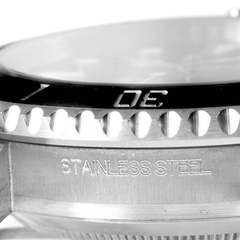 The image shows a close-up side view of a Rolex Submariner 116610 Men
s Stainless Steel Black Dial 116610 Men
s Stainless Steel Black Dial
s bezel and case, highlighting the "STAINLESS STEEL" inscription.