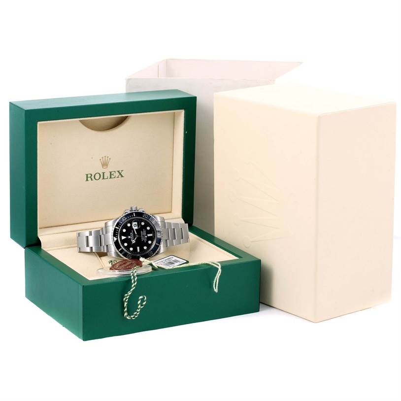 The Rolex Submariner 116610 Men
s Stainless Steel Black Dial 116610 Men
s Stainless Steel Black Dial watch is displayed in its green and beige box with tags and accessories visible.