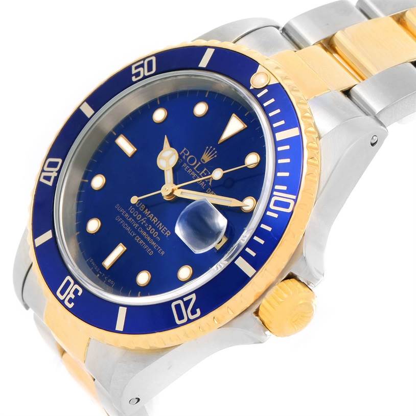 The image shows a close-up angled view of the face and bezel of a Rolex Submariner 16613 Men
s Steel and Gold (two tone) Black Dial 16613 Men
s Steel and Gold (two tone) Black Dial watch.
