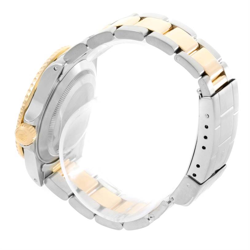 The image shows the side view of a Rolex Submariner 16613 Men
s Steel and Gold (two tone) Black Dial 16613 Men
s Steel and Gold (two tone) Black Dial watch, highlighting its two-tone bracelet, clasp, and crown.