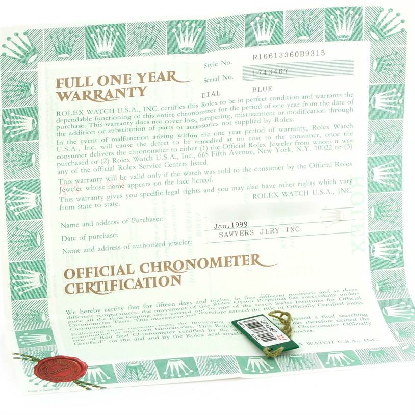 The image shows a one-year warranty certificate and a tag for the Rolex Submariner 16613 Men
s Steel and Gold (two tone) Black Dial 16613 Men
s Steel and Gold (two tone) Black Dial watch, viewed from above.