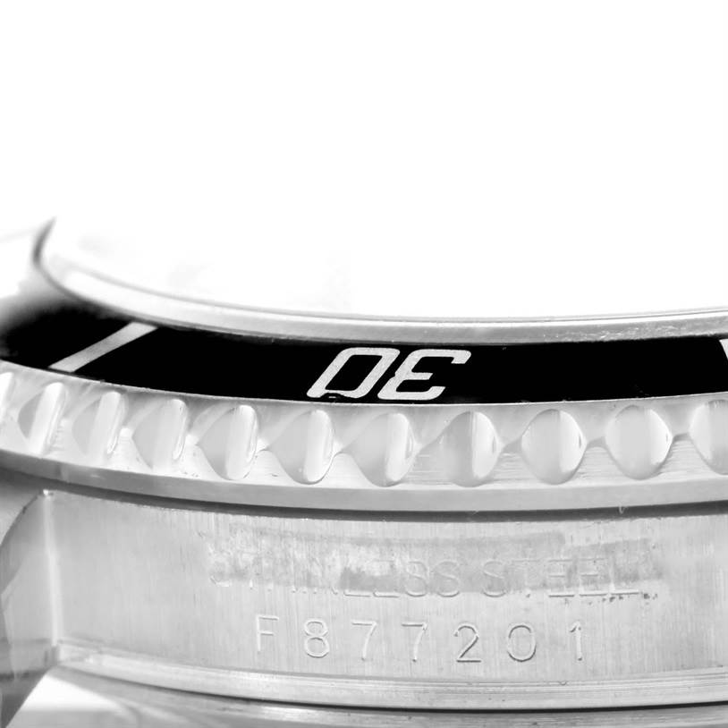 This image shows a close-up of the bezel and serial number on a Rolex Submariner 16610 Men
s Stainless Steel Black Dial 16610 Men
s Stainless Steel Black Dial watch.