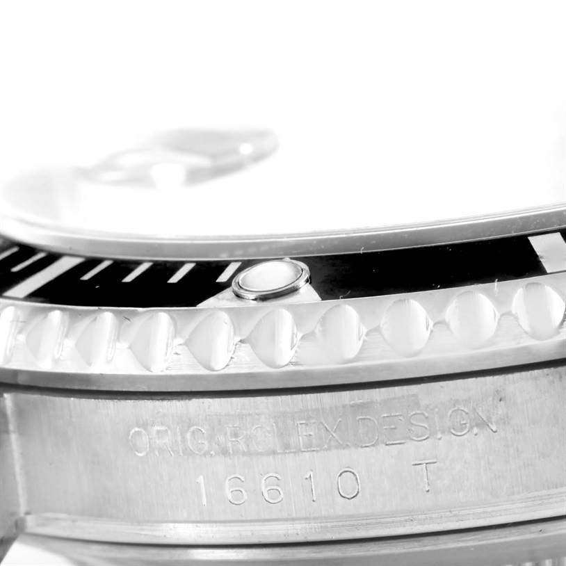 This is a close-up view of the bezel and case of a Rolex Submariner 16610 Men
s Stainless Steel Black Dial 16610 Men
s Stainless Steel Black Dial watch, showing the model number 16610 T.