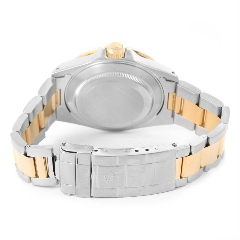 The image shows the back view of the Rolex Submariner 16613 Men
s Steel and Gold (two tone) Black Dial 16613 Men
s Steel and Gold (two tone) Black Dial watch, highlighting the case back and two-tone bracelet.