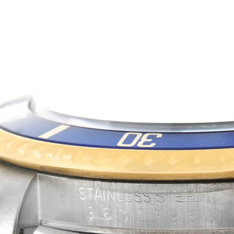 This is a close-up of the bezel and part of the case, showcasing the "30" marking on a Rolex Submariner 16803 Men's Steel and Gold (two tone) Blue Dial 16803 Men's Steel and Gold (two tone) Blue Dial watch.