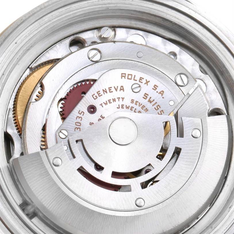 The image shows the intricate movement mechanism of the Rolex Submariner 16803 Men's Steel and Gold (two tone) Blue Dial 16803 Men's Steel and Gold (two tone) Blue Dial watch from the back.