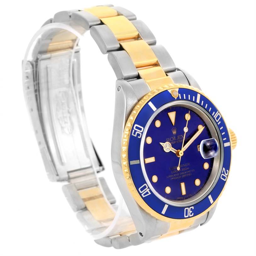 The image shows a Rolex Submariner 16803 Men's Steel and Gold (two tone) Blue Dial 16803 Men's Steel and Gold (two tone) Blue Dial watch angled slightly to the right, displaying its blue dial, bezel, and two-tone bracelet.