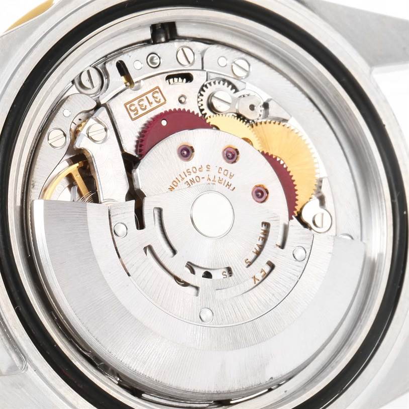 This image shows the intricate internal mechanism of a Rolex Submariner 16613 Men's Steel and Gold (two tone) Blue Dial 16613 Men's Steel and Gold (two tone) Blue Dial watch at a close angle.