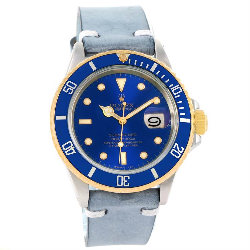 The Rolex Submariner 16613 Men's Steel and Gold (two tone) Blue Dial 16613 Men's Steel and Gold (two tone) Blue Dial watch is shown from a front angle, showcasing its blue dial, bezel, and grey leather strap.