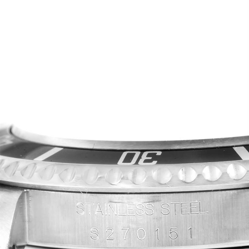 The image shows a close-up of the side and bezel of a Rolex Submariner 14060 Men
s Stainless Steel Black Dial 14060 Men
s Stainless Steel Black Dial watch, highlighting the "30" mark and "STAINLESS STEEL" engraving.