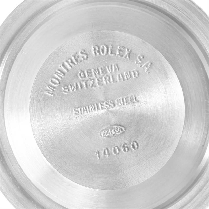 The image shows the interior of the case back of a Rolex Submariner 14060 Men
s Stainless Steel Black Dial 14060 Men
s Stainless Steel Black Dial, engraved with the brand name and model number 14060.