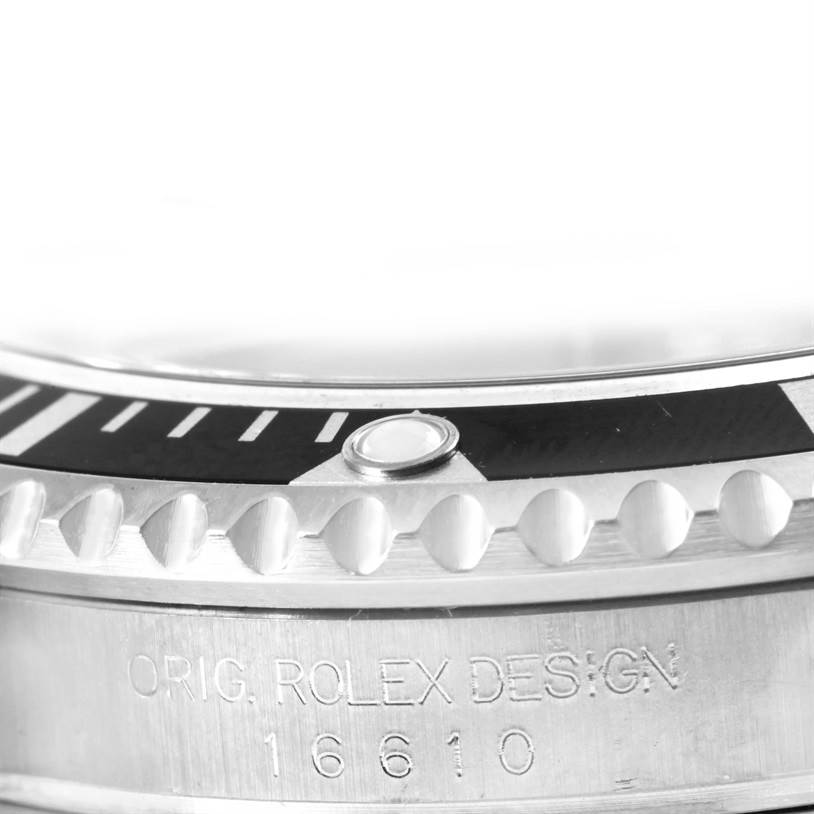 This close-up image shows the bezel and part of the casing with the model number "16610" engraved on the Rolex Submariner 16610 Men
s Stainless Steel Black Dial 16610 Men
s Stainless Steel Black Dial watch.