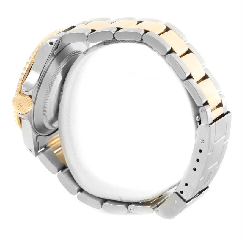 The image shows the side view of the Rolex Submariner 16613 Men
s Steel and Gold (two tone) Grey Dial 16613 Men
s Steel and Gold (two tone) Grey Dial watch, focusing on the crown, case, and bracelet.