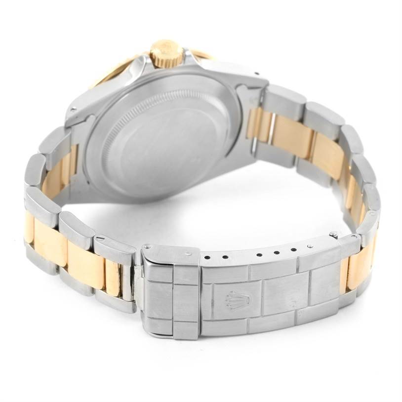 The image shows the back and the bracelet of the Rolex Submariner 16613 Men
s Steel and Gold (two tone) Grey Dial 16613 Men
s Steel and Gold (two tone) Grey Dial watch, highlighting the clasp and case back.