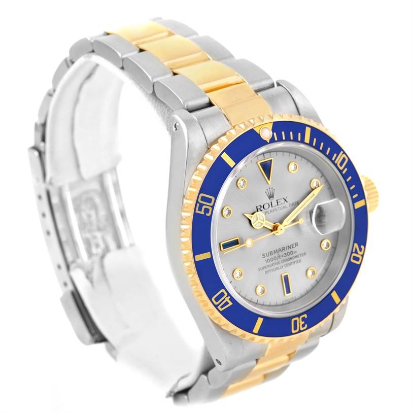 The image shows a Rolex Submariner 16613 Men
s Steel and Gold (two tone) Grey Dial 16613 Men
s Steel and Gold (two tone) Grey Dial watch angled to display the face, bezel, and part of the bracelet.