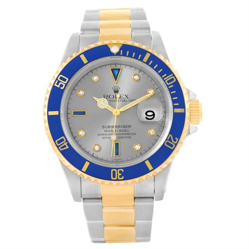 The image shows a frontal view of a Rolex Submariner 16613 Men
s Steel and Gold (two tone) Grey Dial 16613 Men
s Steel and Gold (two tone) Grey Dial watch, highlighting its blue bezel and two-tone metal bracelet.