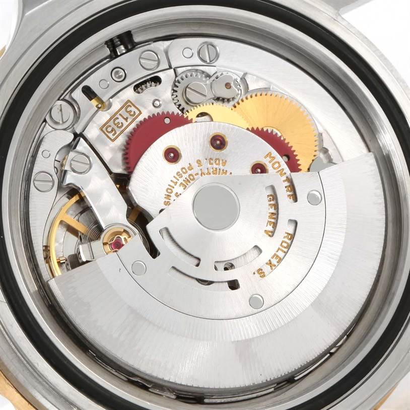 The image shows a close-up of the movement mechanism of the Rolex Submariner 16613 Men
s Steel and Gold (two tone) Black Dial 16613 Men
s Steel and Gold (two tone) Black Dial watch from the back.