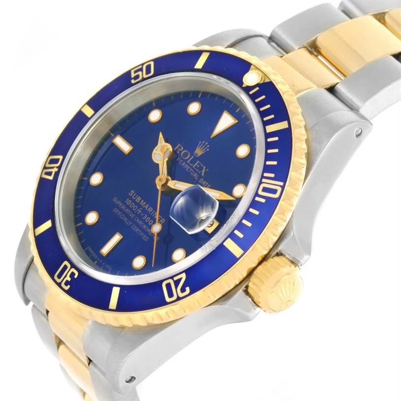 The image shows a close-up of the Rolex Submariner 16613 Men
s Steel and Gold (two tone) Black Dial 16613 Men
s Steel and Gold (two tone) Black Dial, highlighting the blue dial, bezel, gold accents, and bracelet.