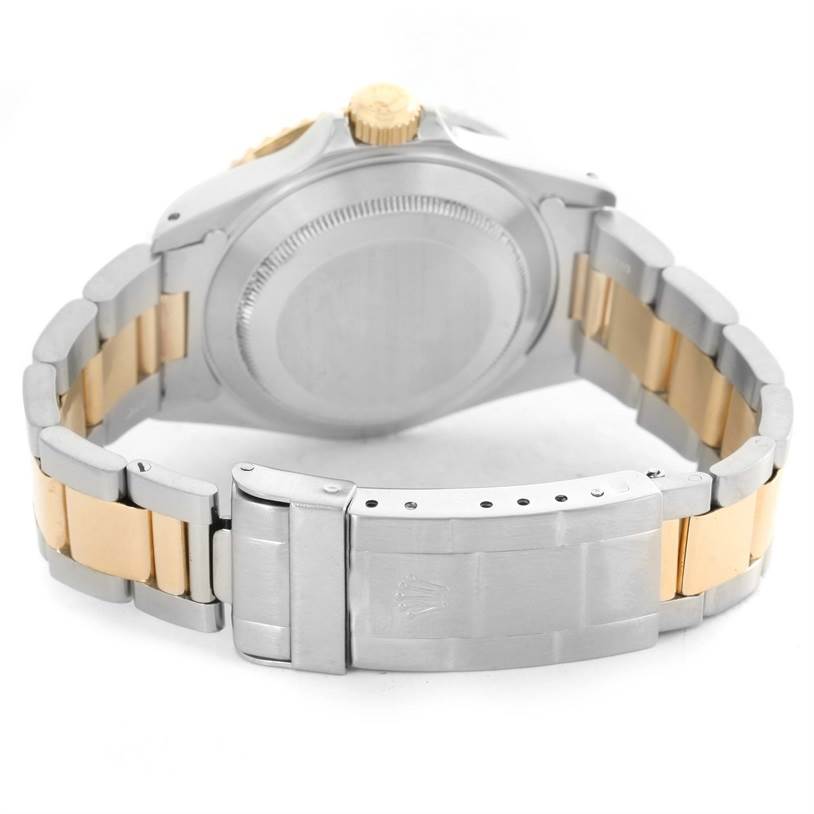 The image shows the back case and clasp of a Rolex Submariner 16613 Men
s Steel and Gold (two tone) Black Dial 16613 Men
s Steel and Gold (two tone) Black Dial watch, displaying its two-tone metal bracelet.