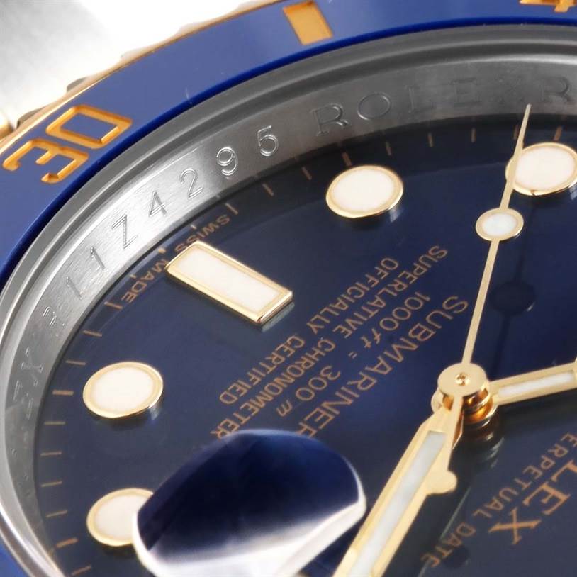 Close-up angle showing the dial, markers, hands, and part of the bezel of the Rolex Submariner 116613 Men's Steel and Gold (two tone) Blue Dial 116613 Men's Steel and Gold (two tone) Blue Dial watch.