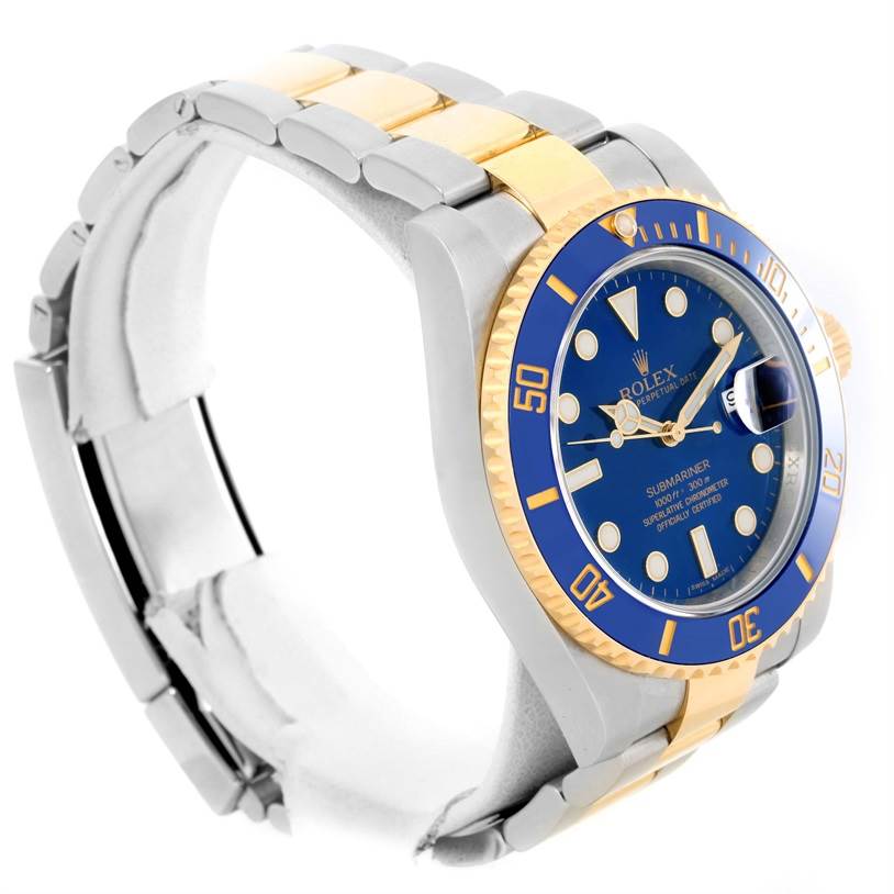 The image shows an angled view of a Rolex Submariner 116613 Men's Steel and Gold (two tone) Blue Dial 116613 Men's Steel and Gold (two tone) Blue Dial watch, highlighting the blue dial, bezel, and two-tone bracelet.