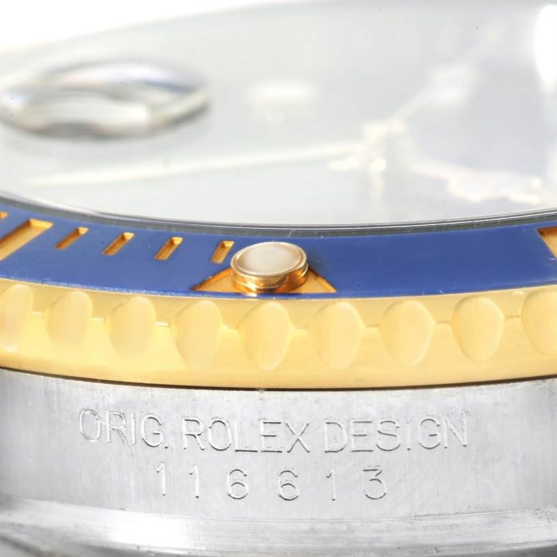 The image shows a close-up of the bezel and engraving on a Rolex Submariner 116613 Men's Steel and Gold (two tone) Blue Dial 116613 Men's Steel and Gold (two tone) Blue Dial watch, model 116613.