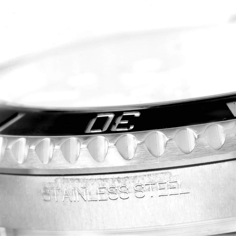 This close-up image shows the bezel and part of the stainless steel case of a Rolex Submariner 116610 Men
s Stainless Steel Black Dial 116610 Men
s Stainless Steel Black Dial watch.